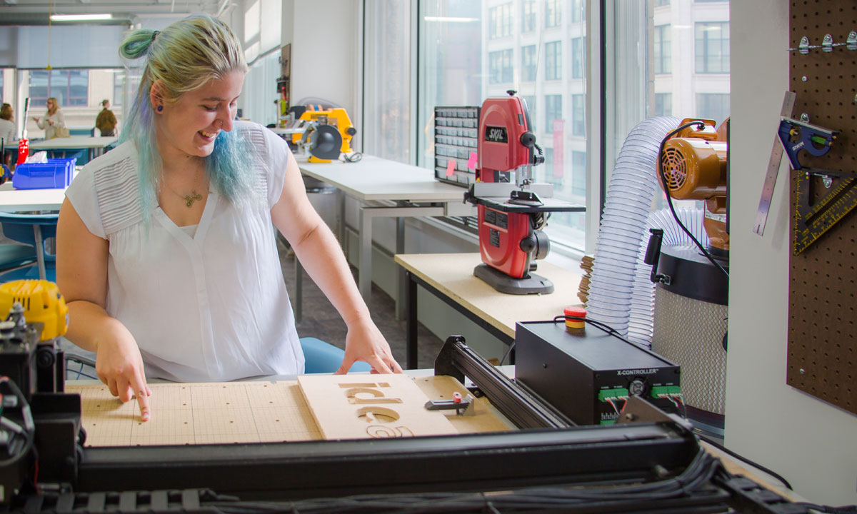 student using a laser cuutting machine