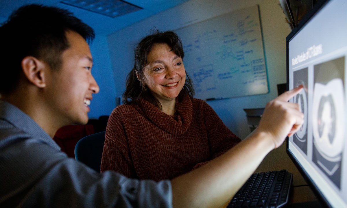 Instructor and student viewing medical image on computer