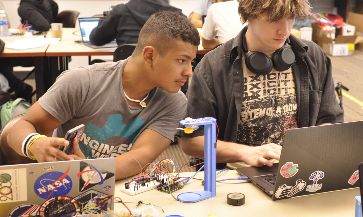 2 high school students coding their circuits