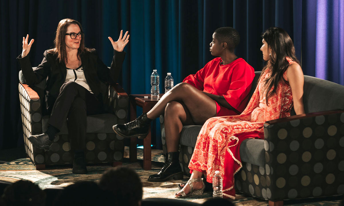 moderator with two guests on stage