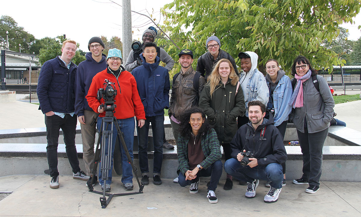 students and teachers group photo with camera outside
