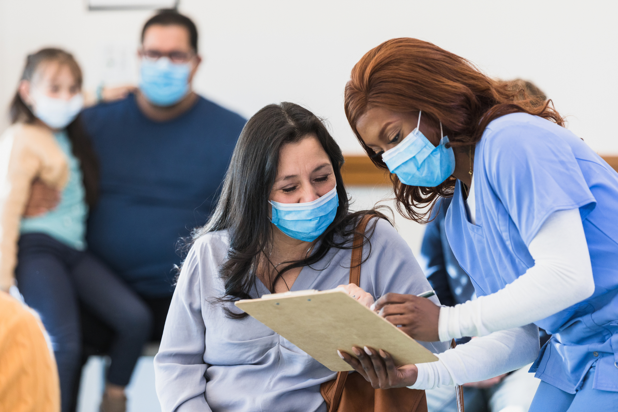 adult woman talking to a nurse