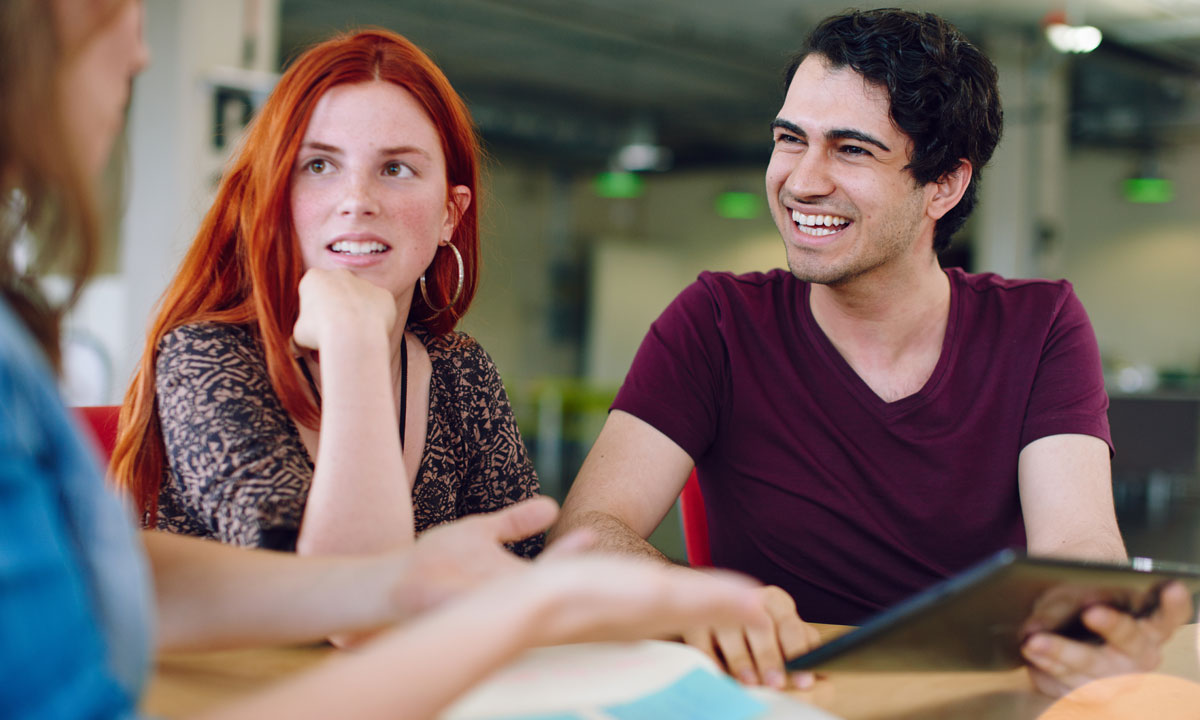 someone explaining to two  students