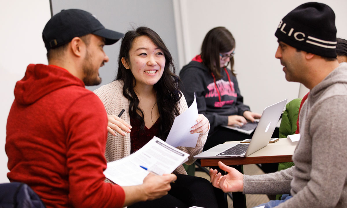 three students talking