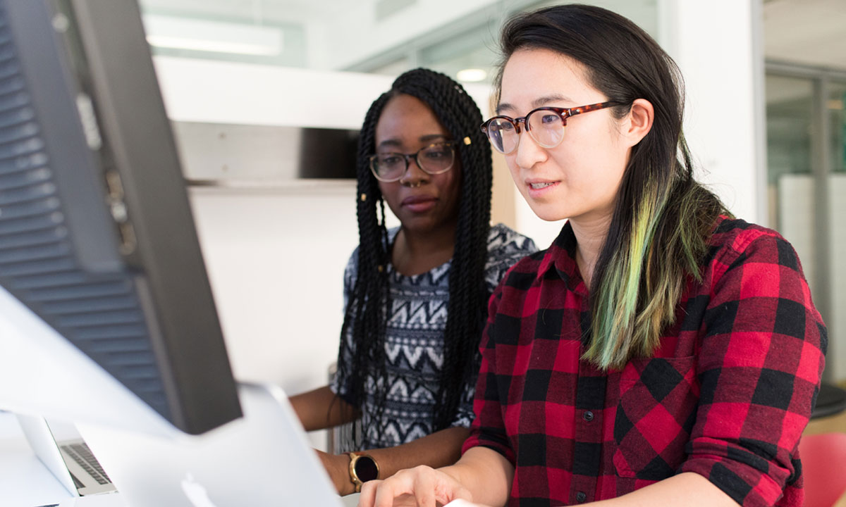 two female students working on a computer