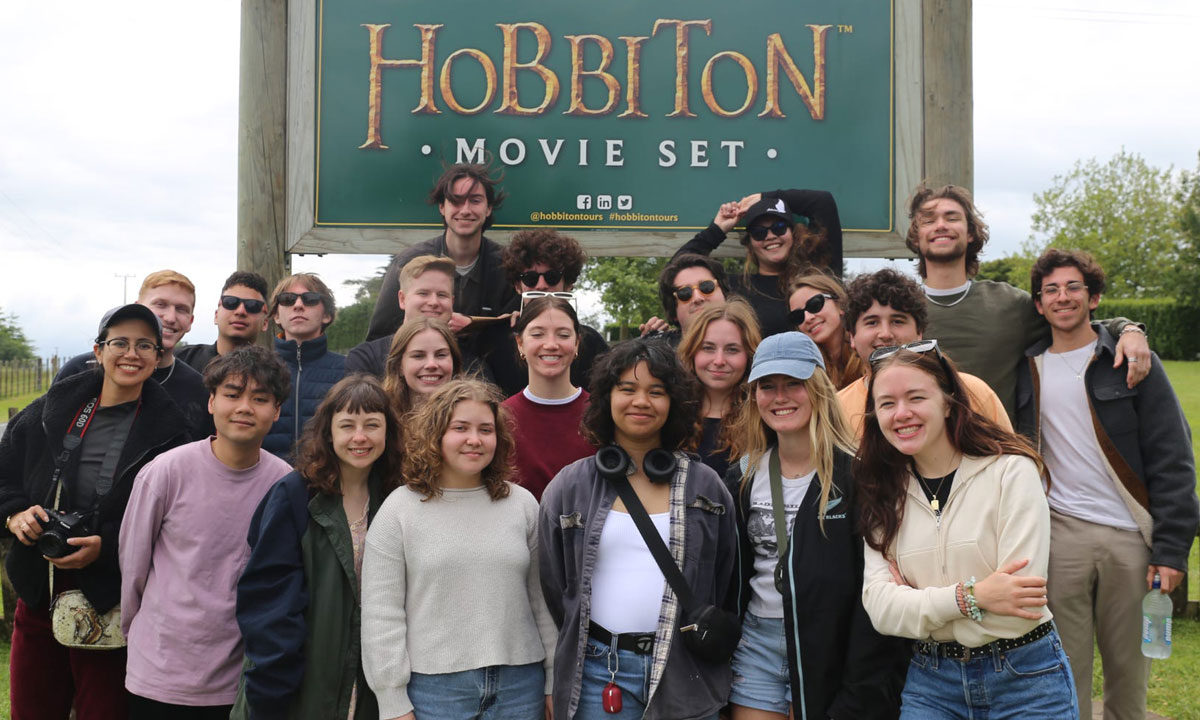 group of DePaul students posing infront of a sign